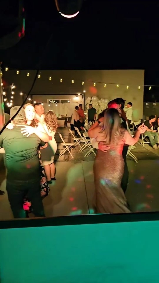 Guests dancing under event lighting at a DJ Lobo celebration
