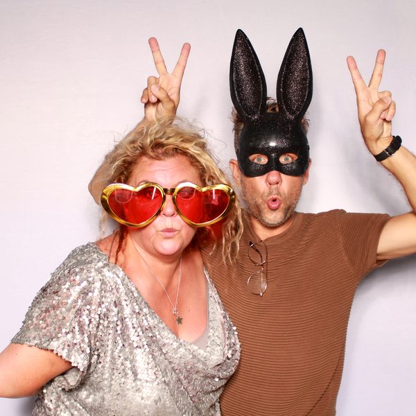 Wedding guests posing in a photo booth